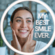 Woman admiring her bright smile in a lighted mirror labeled “My Best Smile Ever,” symbolizing results from the best cosmetic dentist near me.