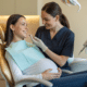 Pregnant woman smiling during a dental visit, demonstrating how pregnancy affects oral health.
