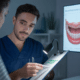 Dentist discussing saliva function and bacteria impact with patient, highlighting the role of saliva in oral health.